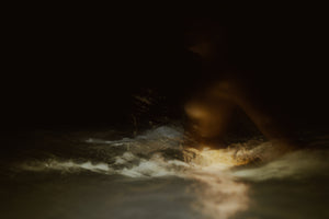 woman fine art portrait at night in ocean