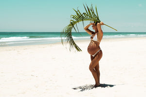 maternity photoshoot on the beach palm leaf by cindy yang